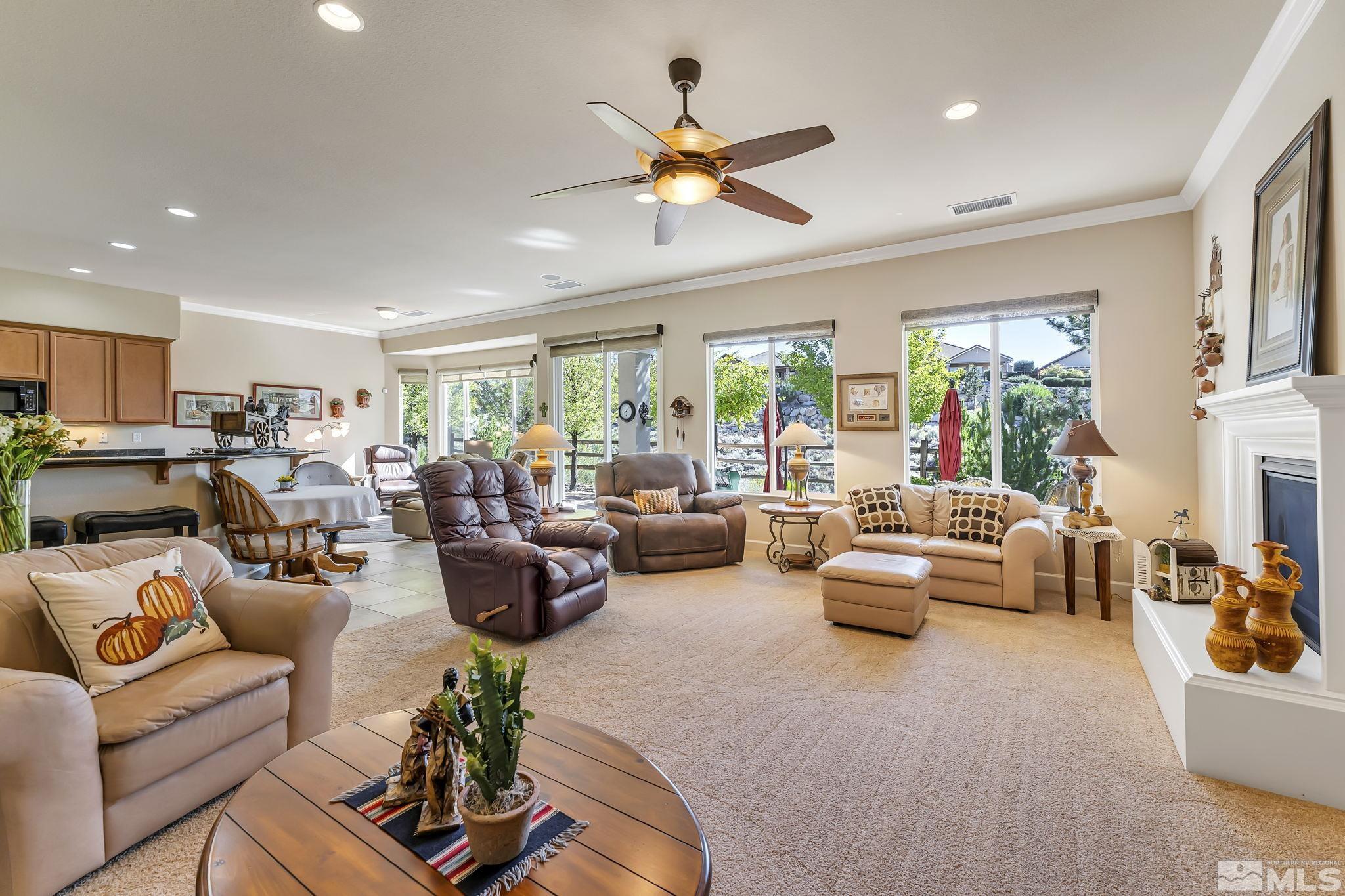 1320 Winterchase Way Reno, NV 89523 - Photo 10 of 37 a living room with furniture fireplace and a large window
