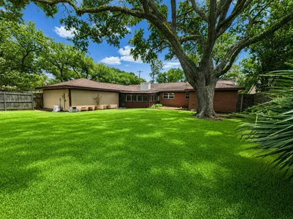 a house with a tree in front of a house