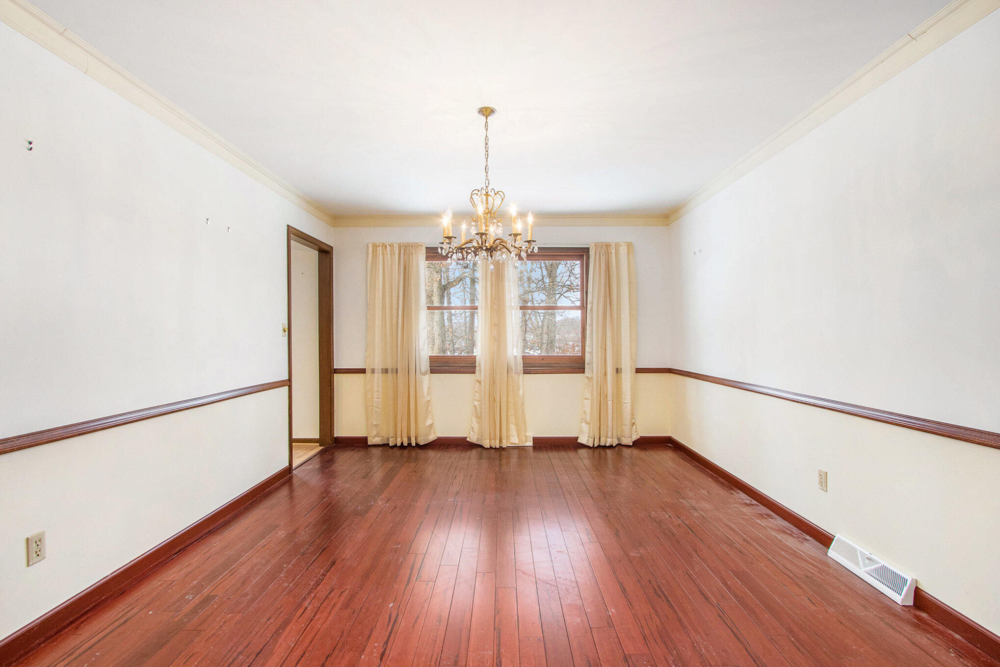 2091 Hidden Valley Drive Crown Point, IN 46307 - Photo 5 of 38 a view of an empty room with window and wooden floor