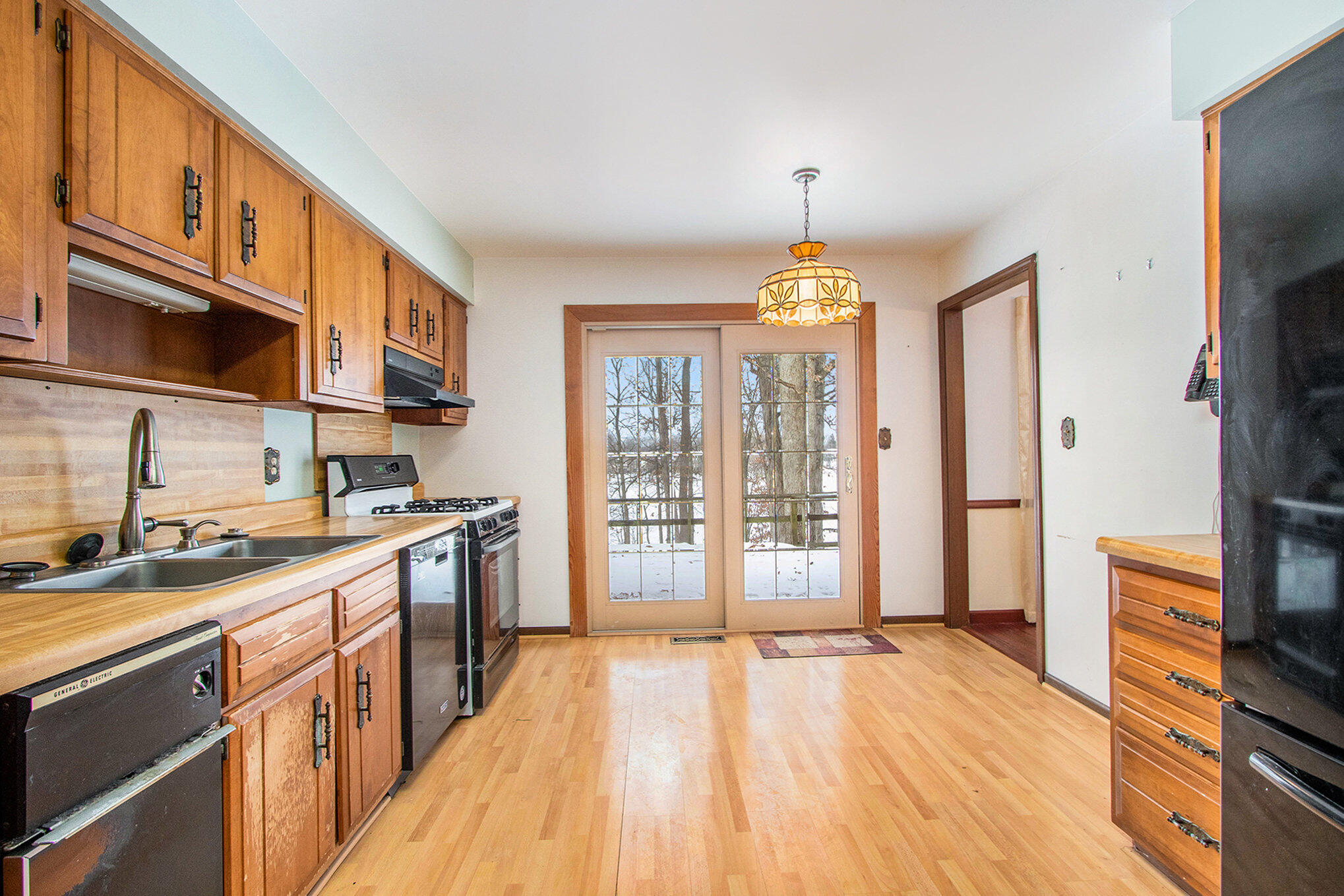 2091 Hidden Valley Drive Crown Point, IN 46307 - Photo 6 of 38 a kitchen with stainless steel appliances granite countertop a sink stove and refrigerator