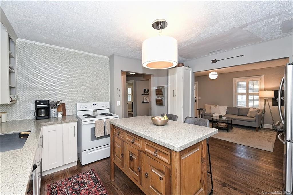 1508 Chippendale Road Charlotte, NC 28205 - Photo 13 of 28 a kitchen that has a sink a stove and a wooden floor