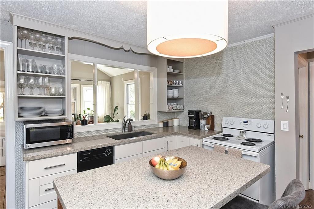 1508 Chippendale Road Charlotte, NC 28205 - Photo 14 of 28 a kitchen with a table chairs and stove