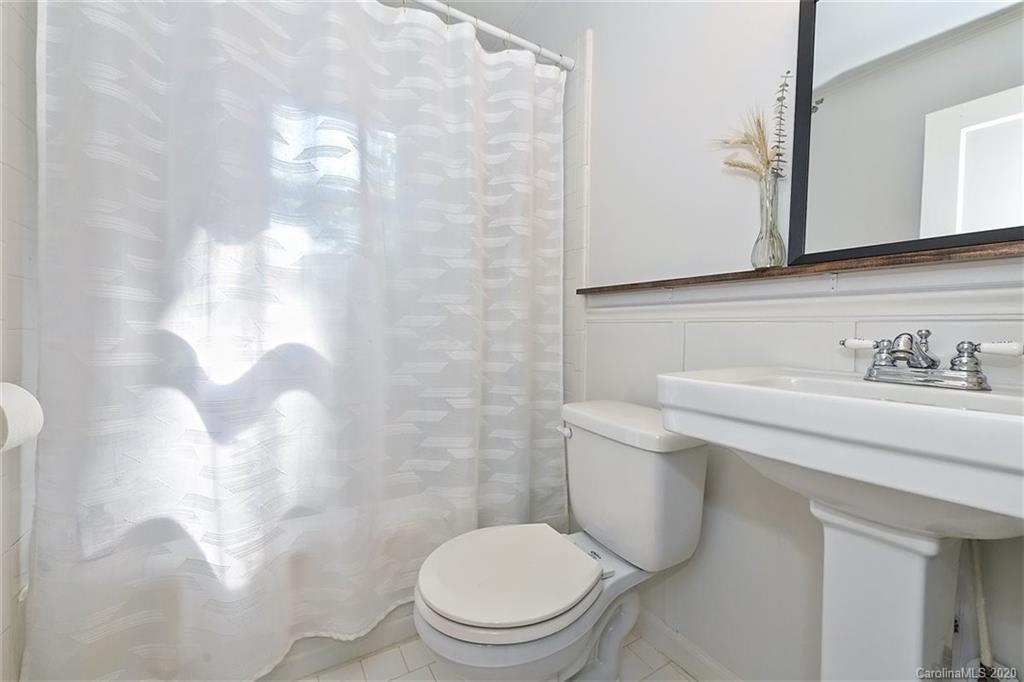 1508 Chippendale Road Charlotte, NC 28205 - Photo 17 of 28 a white toilet sitting next to a bathroom sink