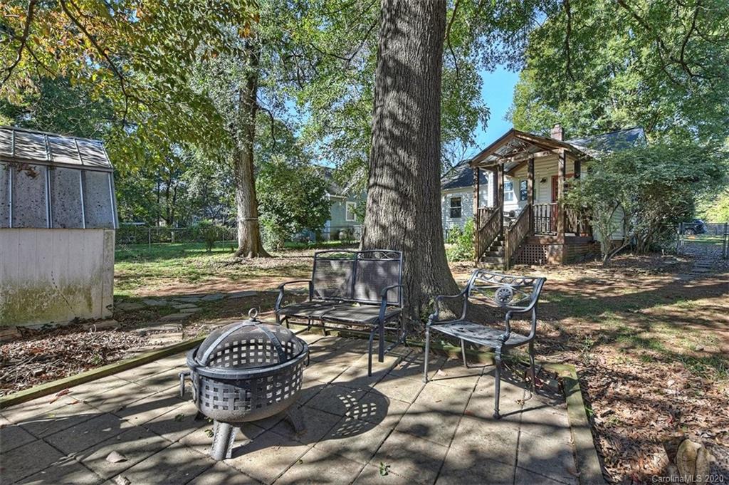 1508 Chippendale Road Charlotte, NC 28205 - Photo 23 of 28 a backyard of a house with barbeque oven and a table and chairs