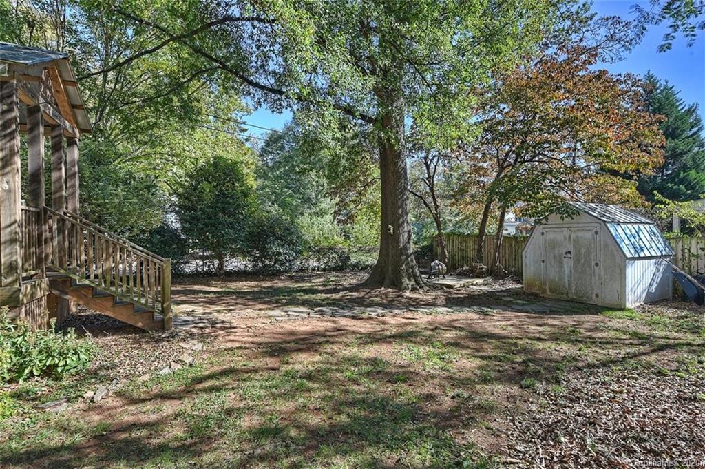 1508 Chippendale Road Charlotte, NC 28205 - Photo 26 of 28 a view of a wooden fence next to a large tree