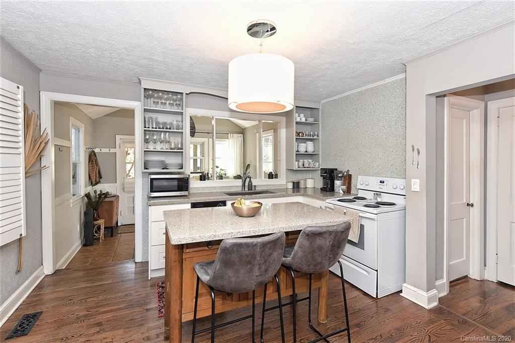 1508 Chippendale Road Charlotte, NC 28205 - Photo 10 of 28 a kitchen with a dining table chairs and refrigerator