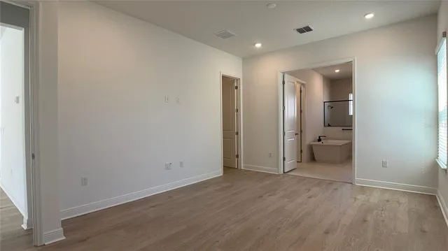 wooden floor in a room with a bathroom