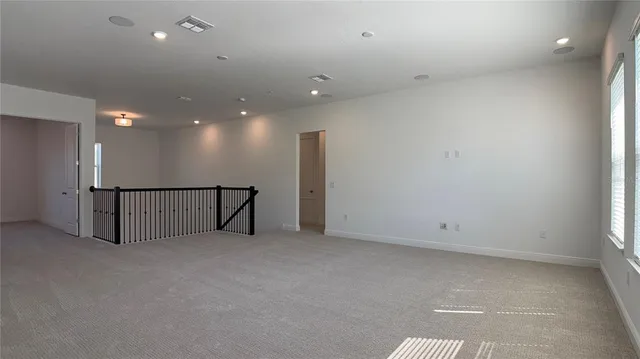 a view of staircase with white walls and windows