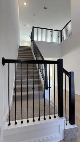 a view of a hallway with wooden floor and entryway