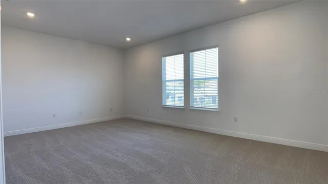 an empty room with an entrance to other room