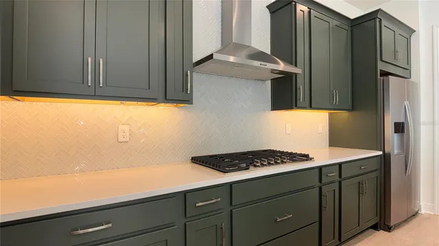 a kitchen with granite countertop a sink cabinets and stainless steel appliances