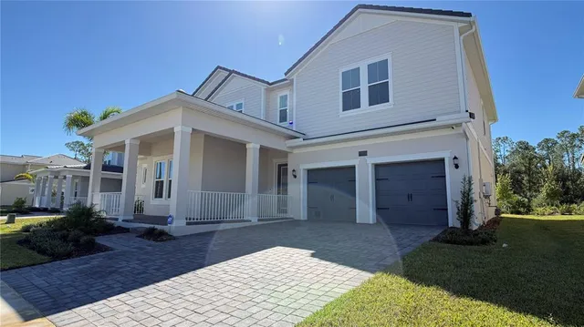 a view of a white house with a yard