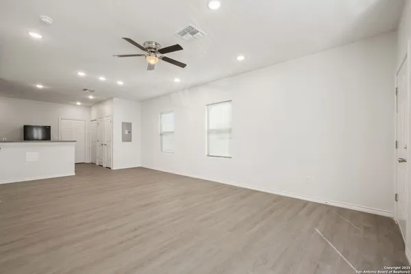 a view of an empty room with a ceiling fan