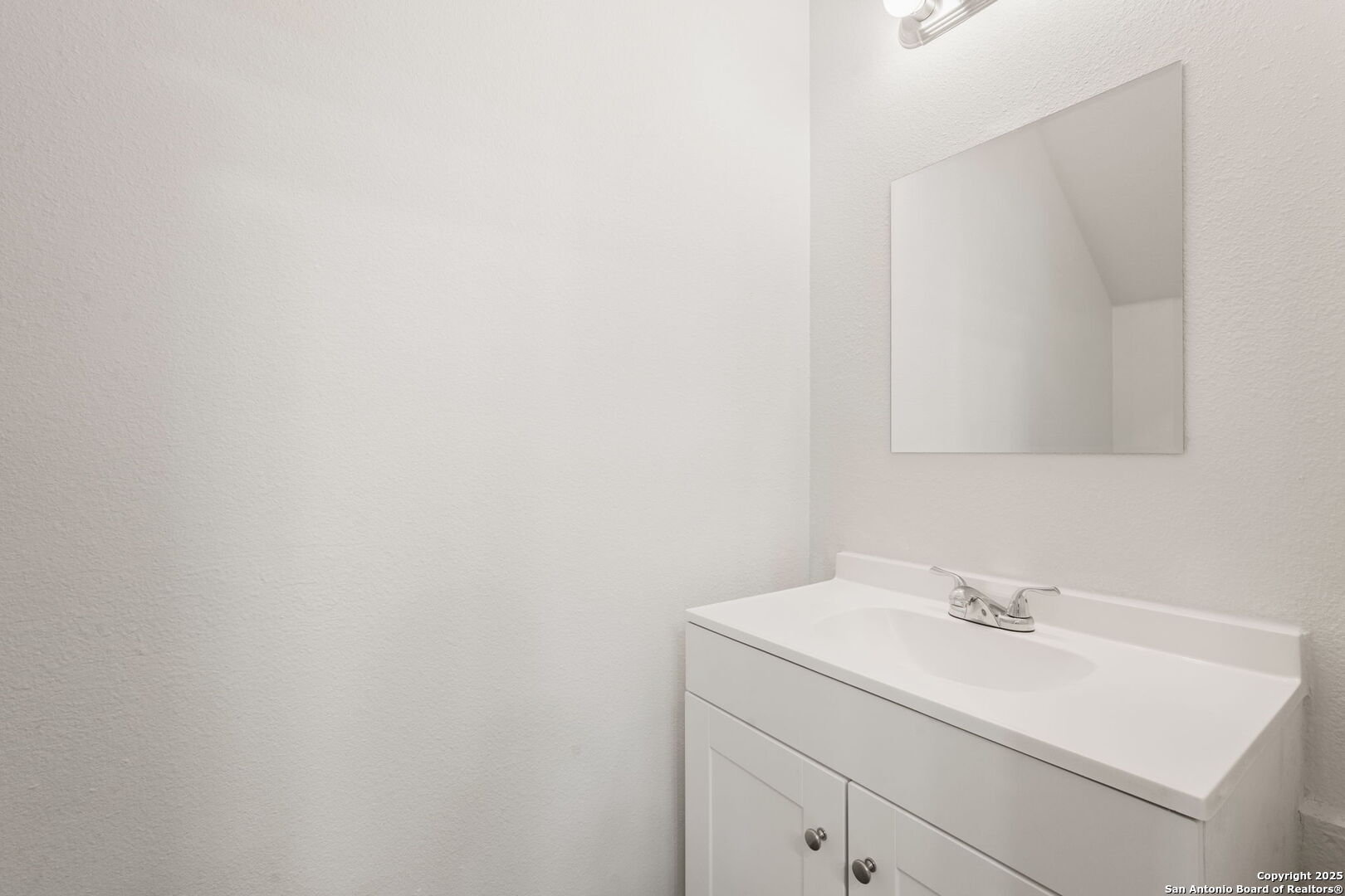 8719 Wurzbach Road, Unit 102 San Antonio, TX 78240 - Photo 5 of 18 a bathroom with a sink and a mirror