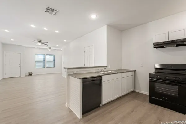 a kitchen with stainless steel appliances granite countertop a stove and a refrigerator