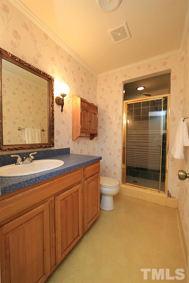 1603 Westhaven Drive Raleigh, NC 27607 - Photo 22 of 30 a bathroom with a double vanity sink and mirror