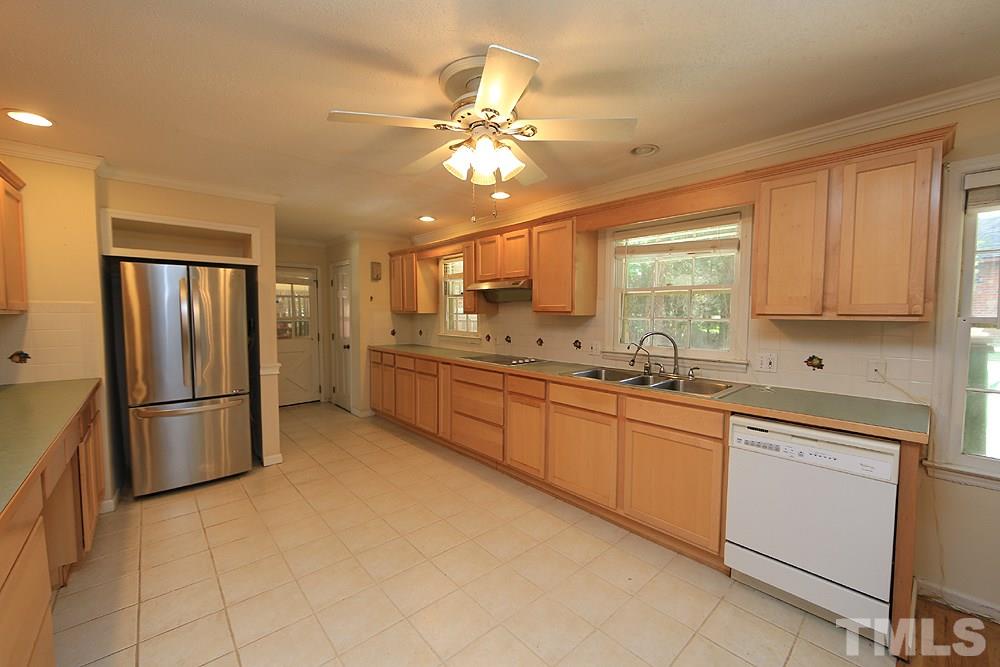 1603 Westhaven Drive Raleigh, NC 27607 - Photo 4 of 30 a kitchen with a refrigerator sink and cabinets