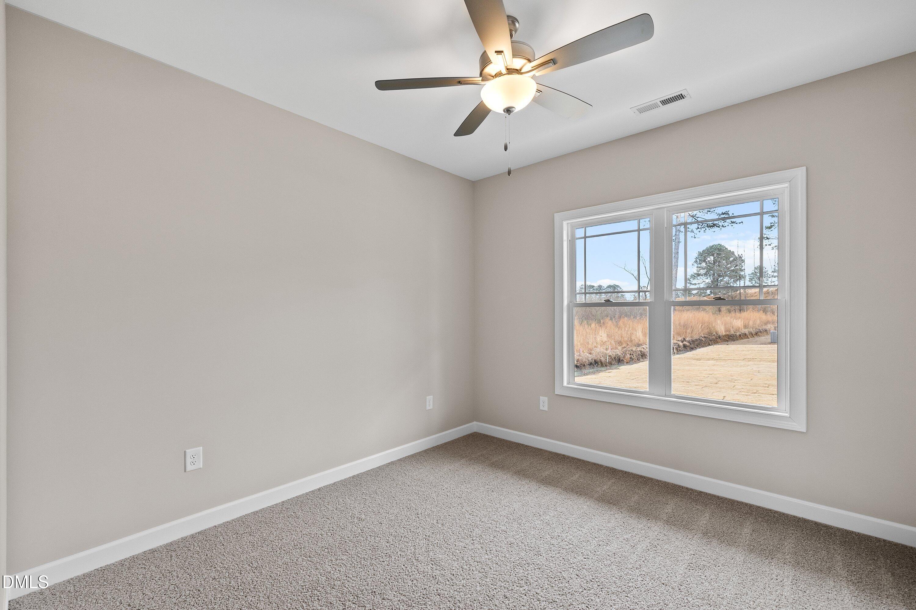 926 Micro Road West Selma, NC 27576 - Photo 29 of 41 an empty room with a window and a fan