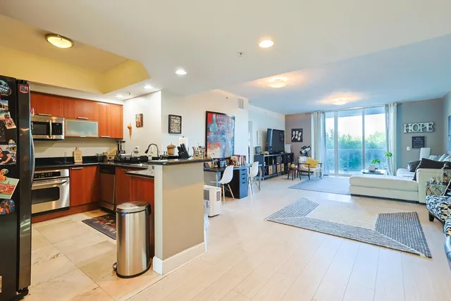 a living room with furniture and a kitchen view
