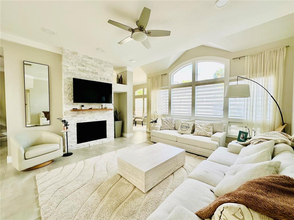 784 South Pennsylvania Avenue Winter Park, FL 32789 - Photo 3 of 29 a living room with furniture a fireplace and a flat screen tv