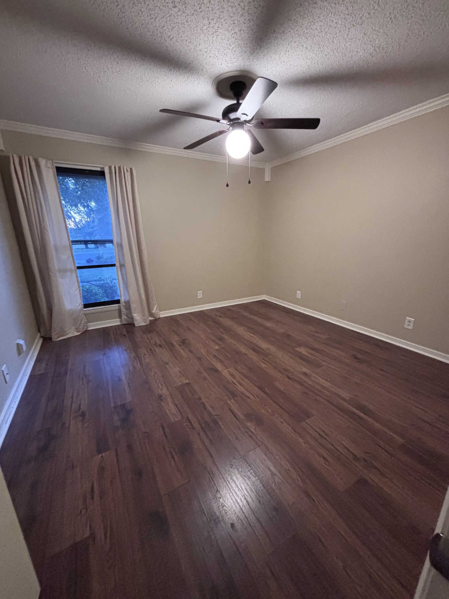 220 Harpers Mill Road Hermitage, TN 37076 - Photo 23 of 46 an empty room with wooden floor fan and windows