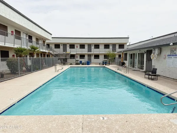 a swimming pool view with a outdoor seating