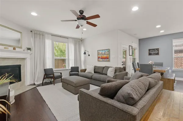 a living room with furniture a fireplace and a flat screen tv