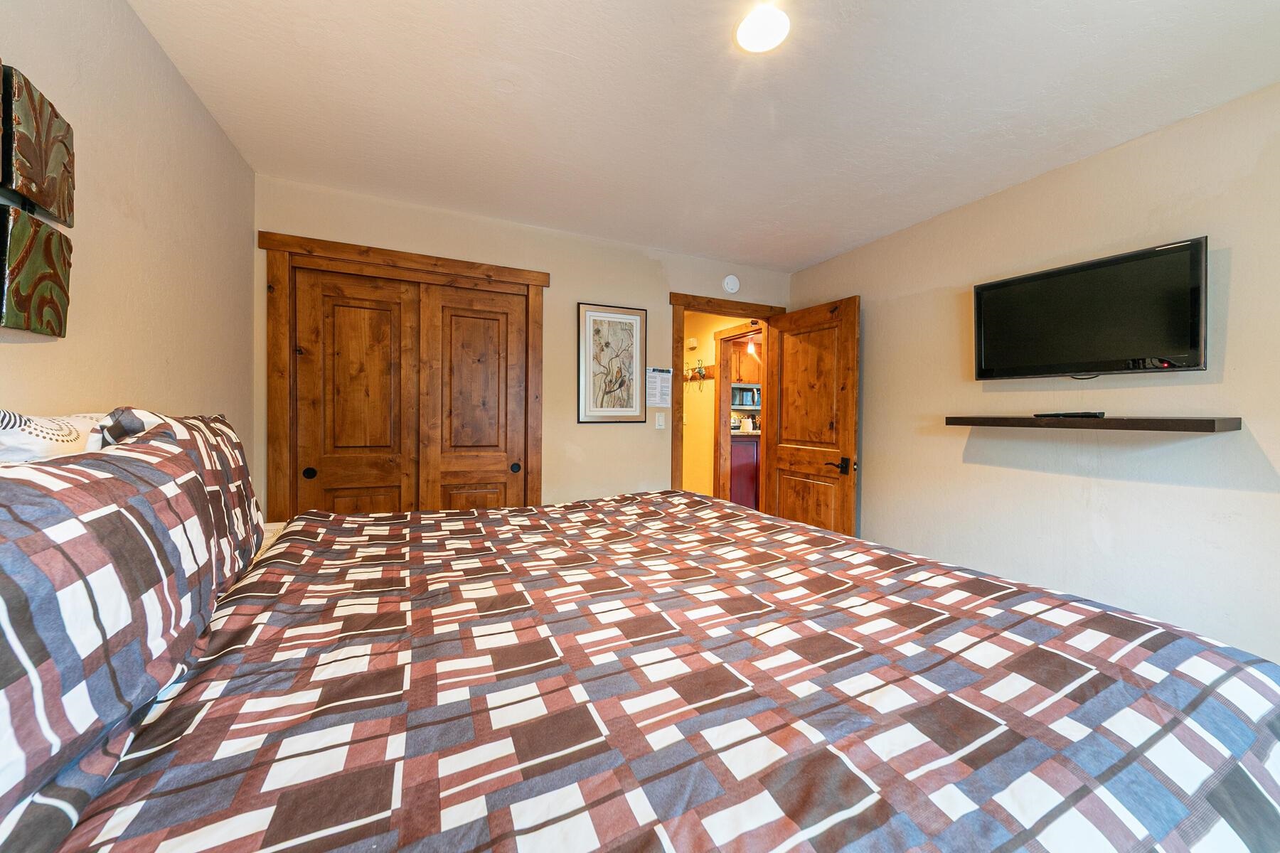 420 Shirley Cyn Road, Unit 34 Olympic Valley, CA 96146 - Photo 19 of 28 a bedroom with a bed and a flat screen tv