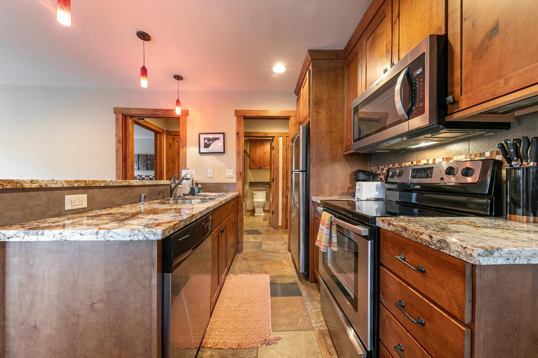 420 Shirley Cyn Road, Unit 34 Olympic Valley, CA 96146 - Photo 3 of 28 a kitchen with stainless steel appliances granite countertop a sink and a stove