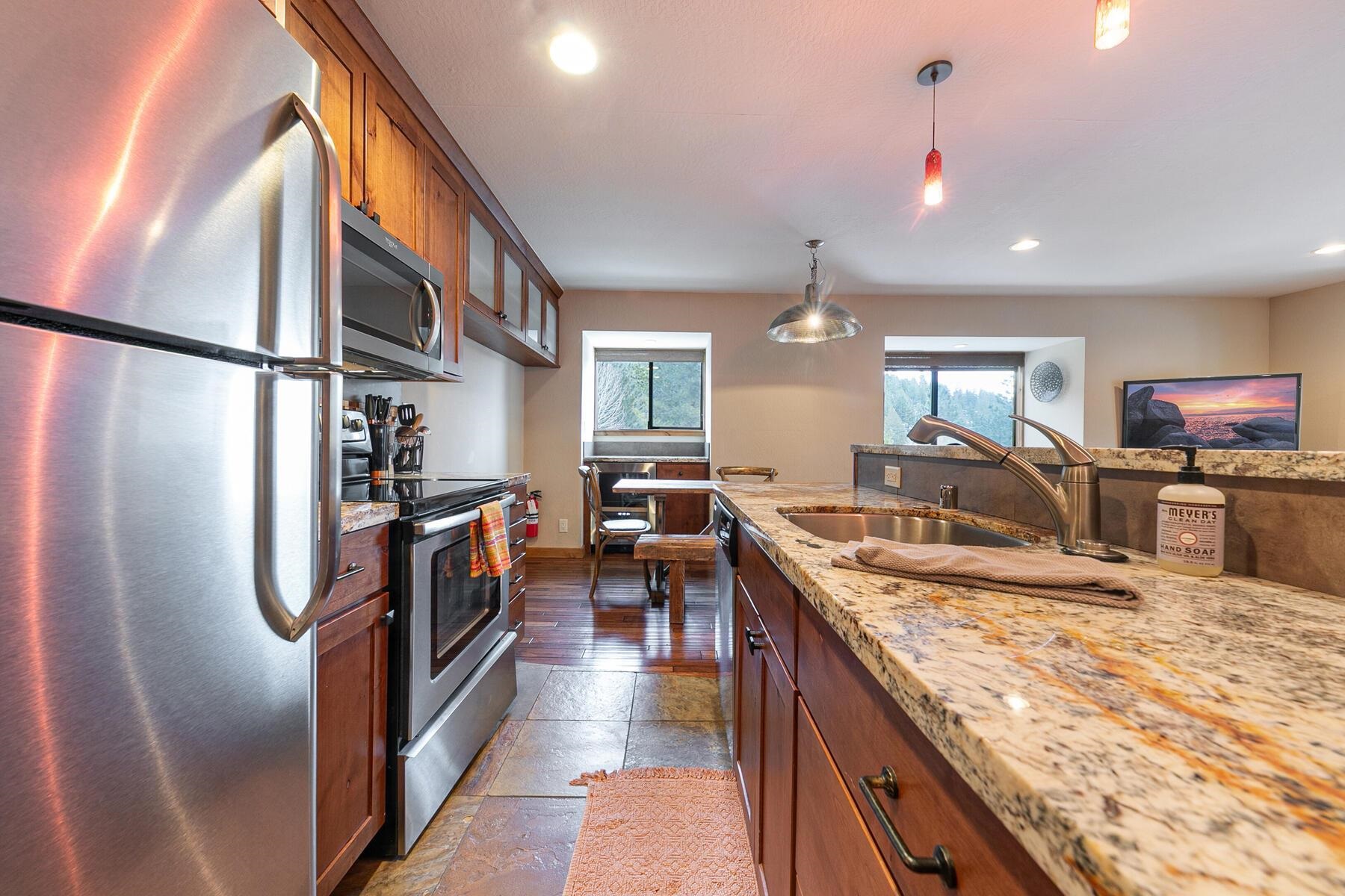 420 Shirley Cyn Road, Unit 34 Olympic Valley, CA 96146 - Photo 4 of 28 a kitchen with stainless steel appliances granite countertop sink stove refrigerator and cabinets
