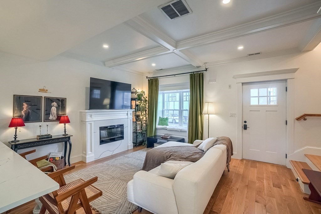 12 South Mason Street, Unit 3 Salem, MA 01970 - Photo 5 of 35 a living room with furniture a fireplace and a flat screen tv