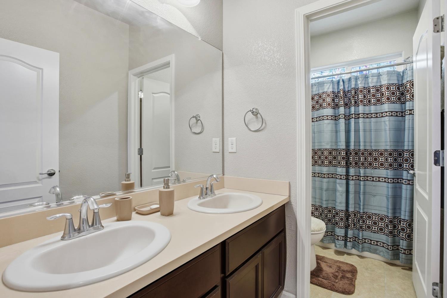 9729 Allen Ranch Way Elk Grove, CA 95757 - Photo 22 of 36 a bathroom with a sink and a mirror