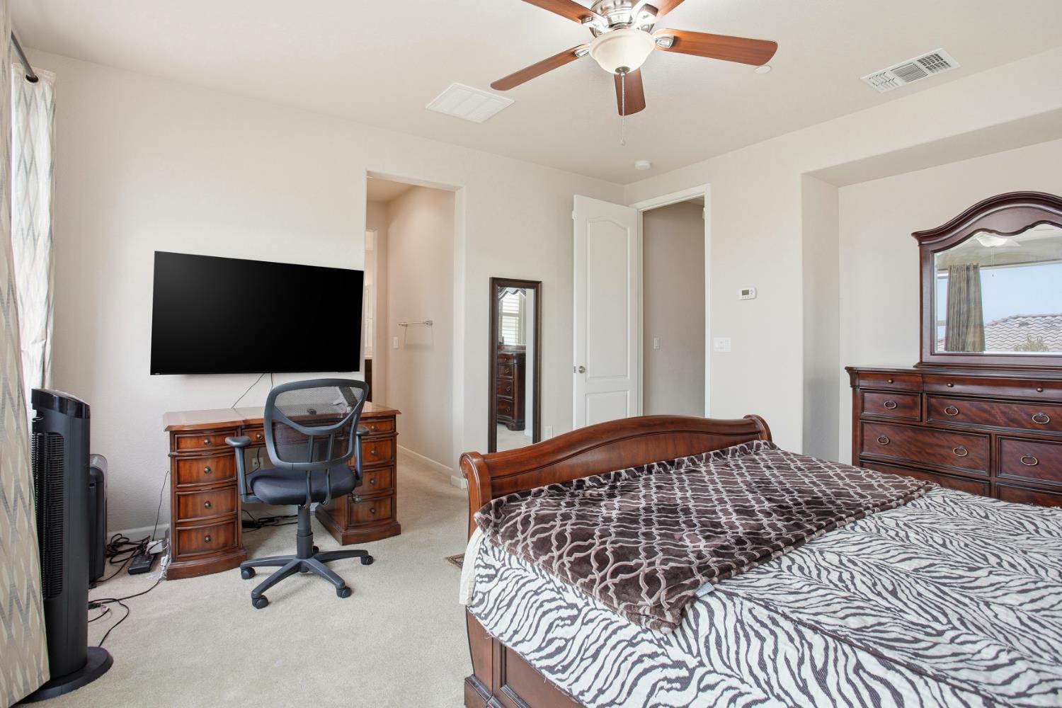 9729 Allen Ranch Way Elk Grove, CA 95757 - Photo 25 of 36 a bedroom with a bed and flat screen tv