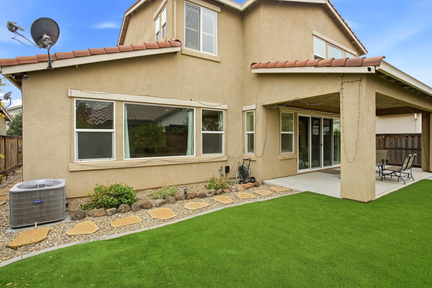 9729 Allen Ranch Way Elk Grove, CA 95757 - Photo 30 of 36 a front view of a house with a garden and yard