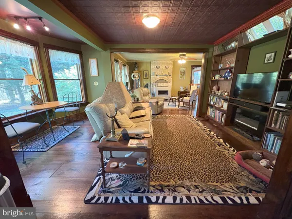 a living room with furniture a fireplace and a chandelier