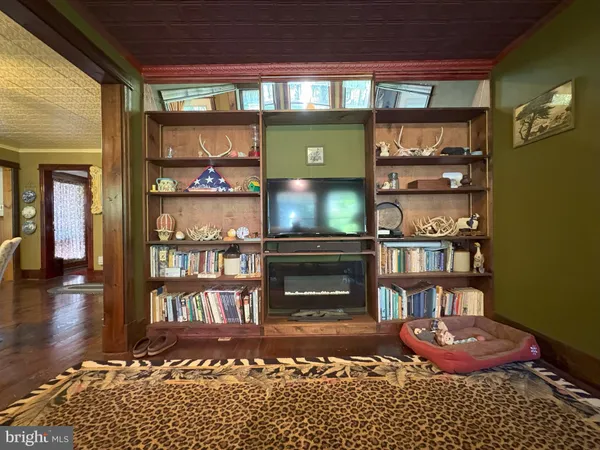 a living room with furniture fireplace and a large window