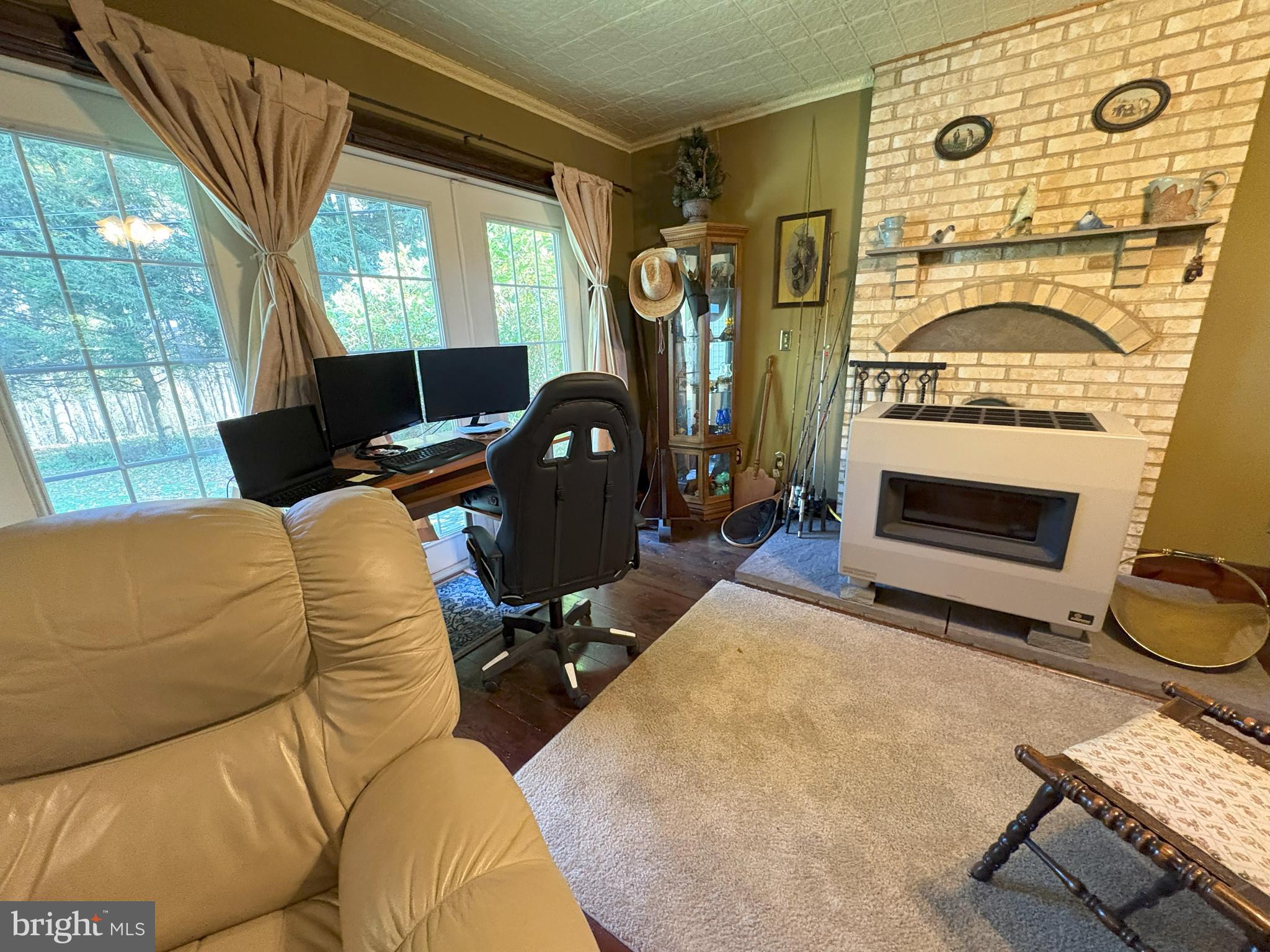 43 Songbird Way Galeton, PA 16922 - Photo 26 of 73 a living room with furniture a fireplace and a floor to ceiling window
