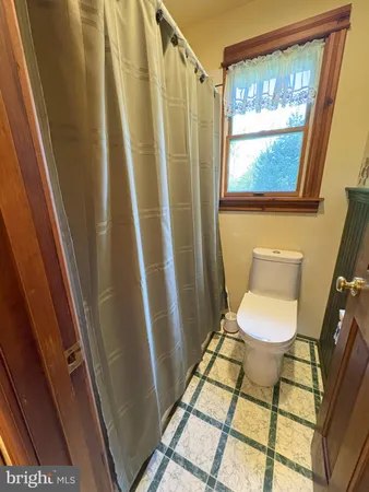 a bedroom with bed and a window