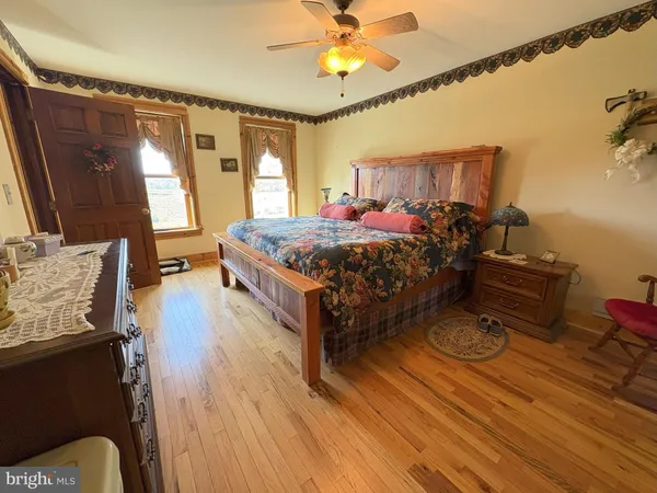 a bedroom with a bed chair and window