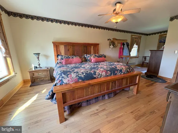 a spacious bedroom with a bed and a window