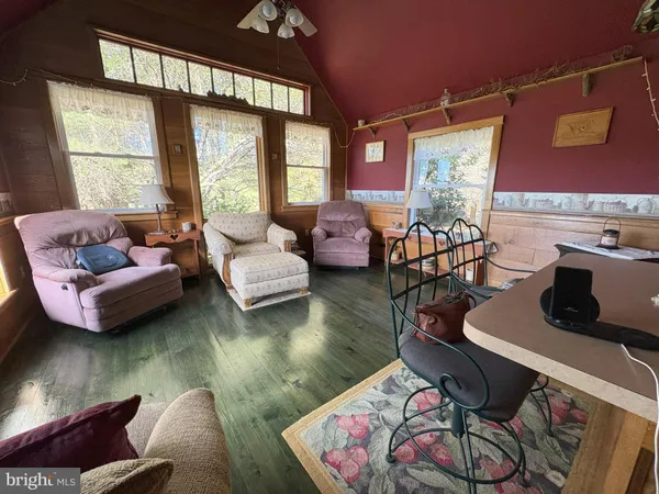 a living room with furniture window and wooden floor