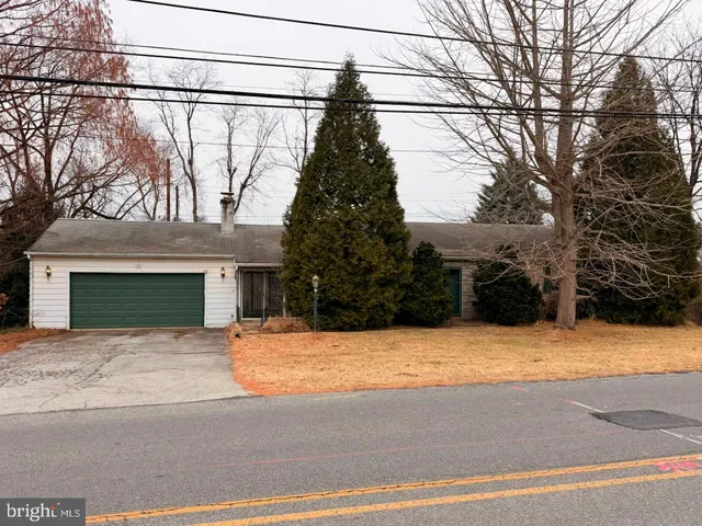 a tall house with trees in front of it