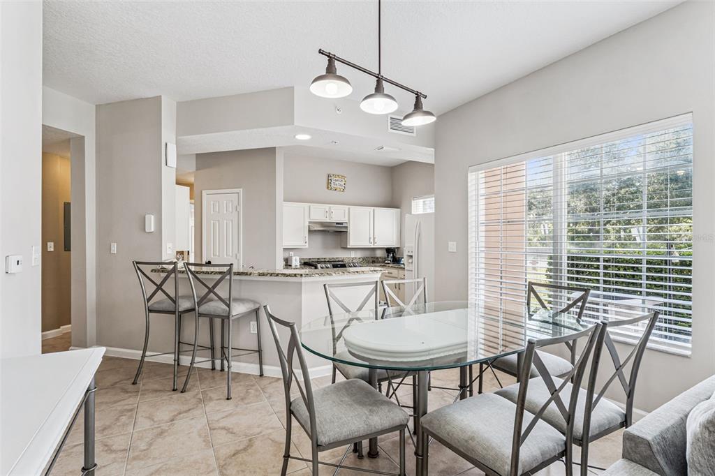 8801 Worldquest Boulevard, Unit 4108 Orlando, FL 32821 - Photo 11 of 85 a view of a dining room with furniture window and outside view