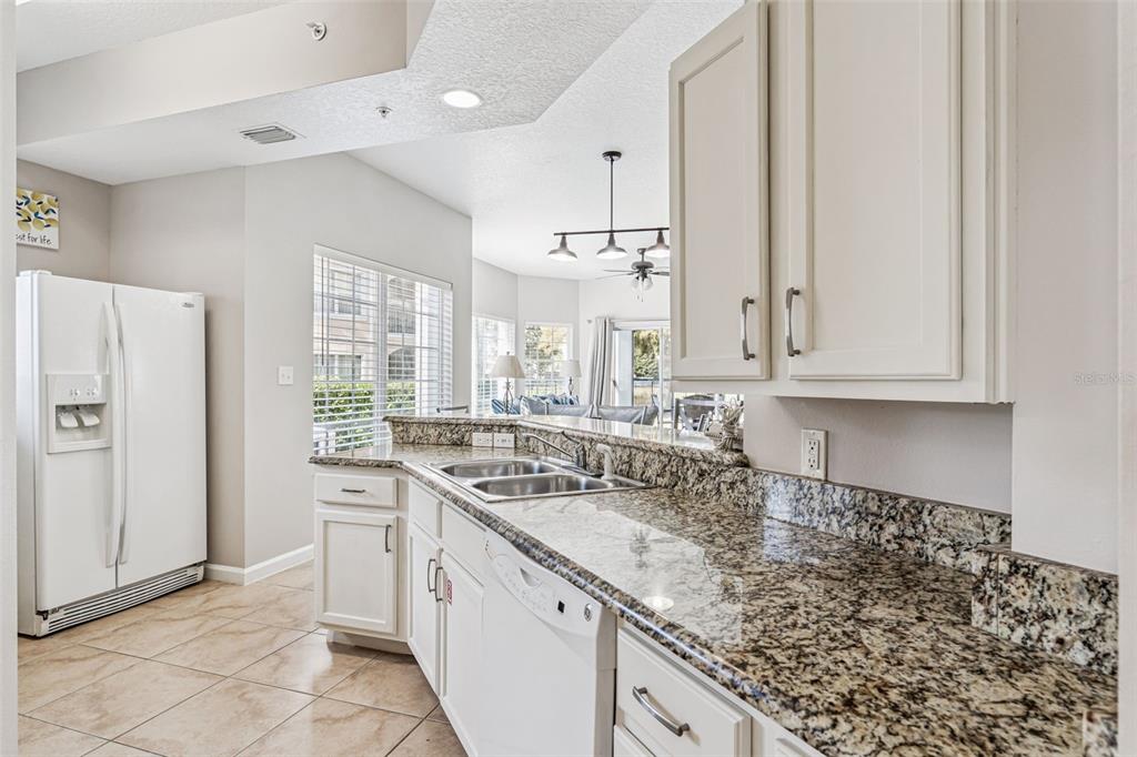 8801 Worldquest Boulevard, Unit 4108 Orlando, FL 32821 - Photo 13 of 85 a kitchen with a sink stove and cabinets