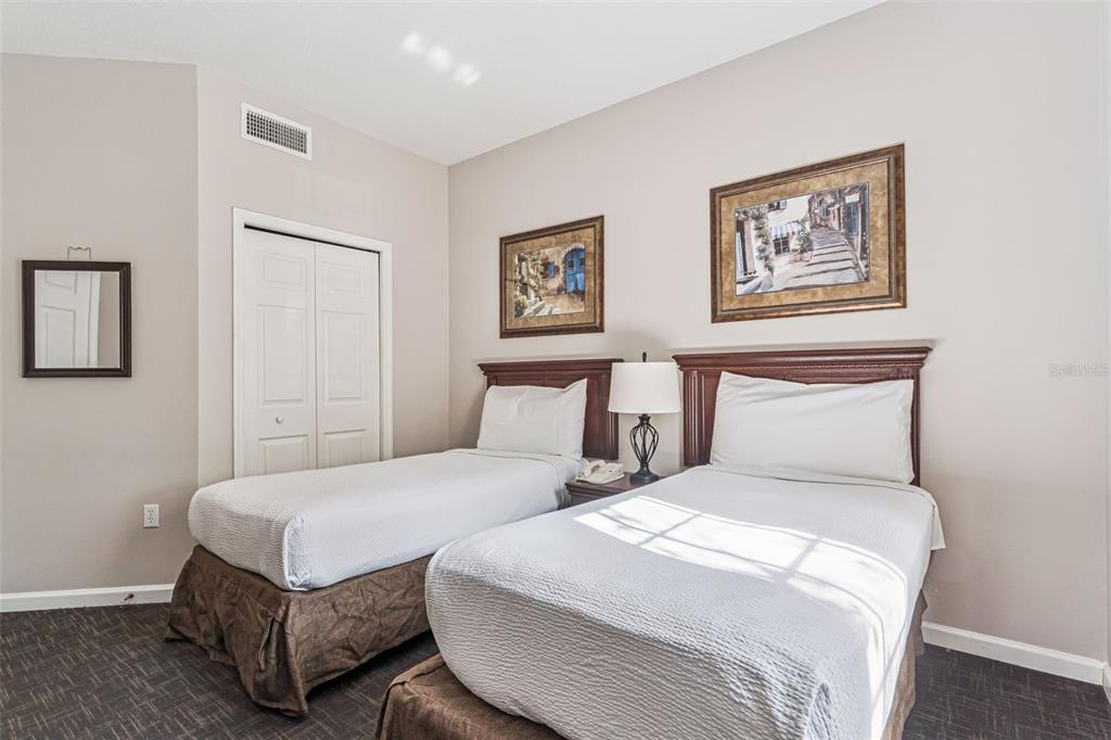 8801 Worldquest Boulevard, Unit 4108 Orlando, FL 32821 - Photo 16 of 85 a bedroom with double bed and a night stand