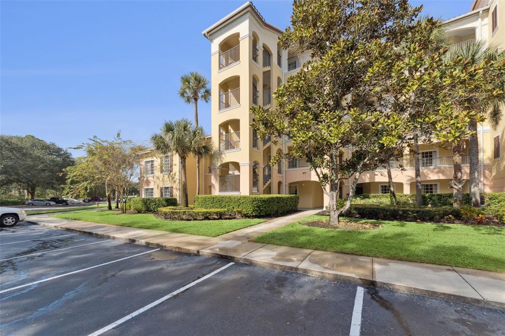 8801 Worldquest Boulevard, Unit 4108 Orlando, FL 32821 - Photo 2 of 85 a front view of a building with a yard and trees