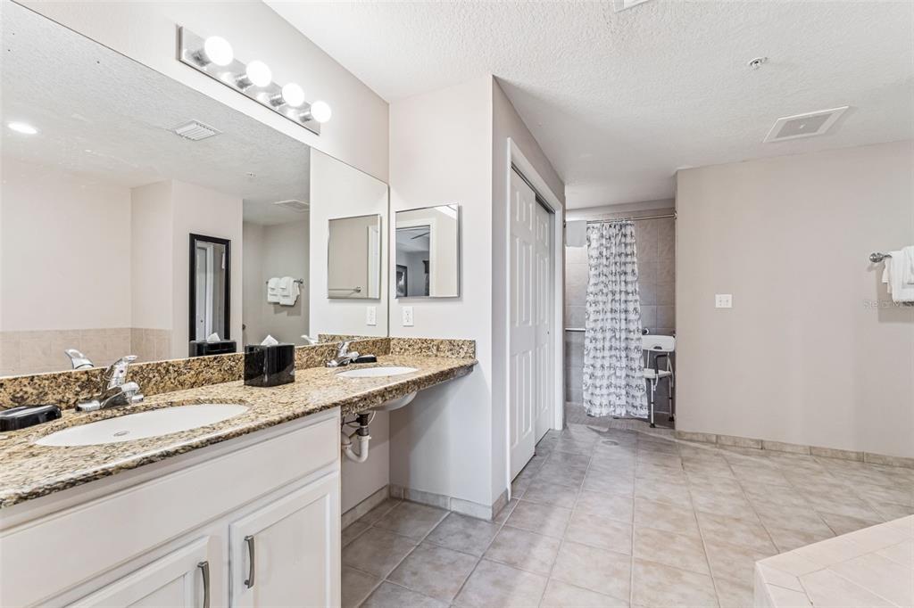 8801 Worldquest Boulevard, Unit 4108 Orlando, FL 32821 - Photo 23 of 85 a bathroom with double sink and a mirror