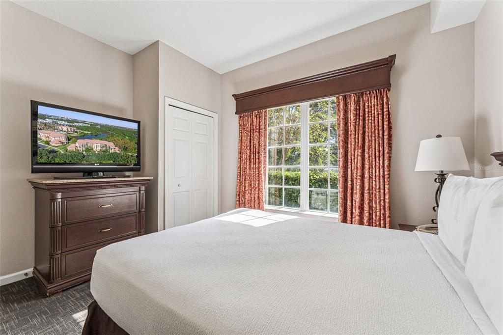 8801 Worldquest Boulevard, Unit 4108 Orlando, FL 32821 - Photo 28 of 85 a bedroom with a bed and a flat screen tv