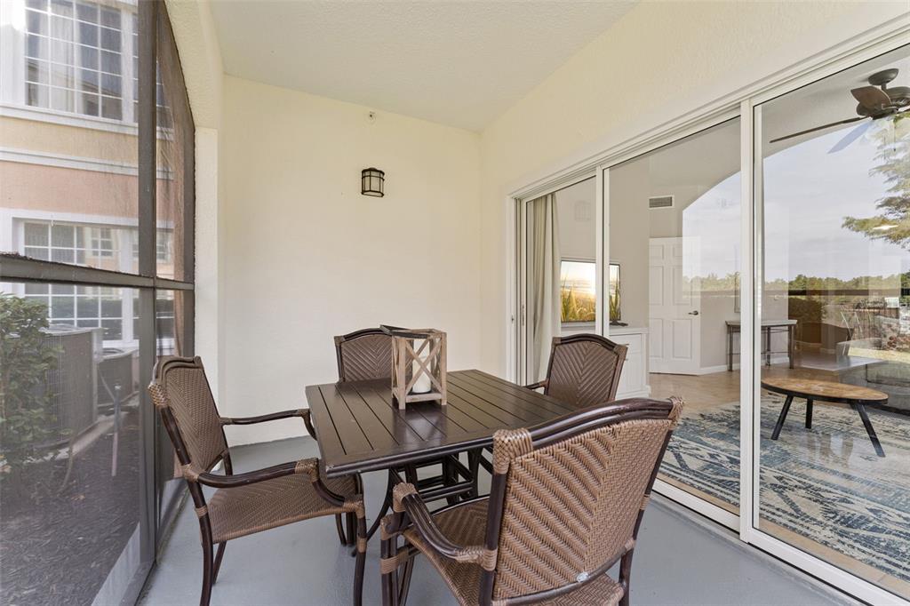 8801 Worldquest Boulevard, Unit 4108 Orlando, FL 32821 - Photo 31 of 85 a view of a dining room with furniture and wooden floor