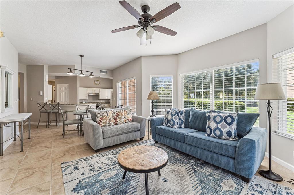 8801 Worldquest Boulevard, Unit 4108 Orlando, FL 32821 - Photo 6 of 85 a living room with furniture a table and a large window